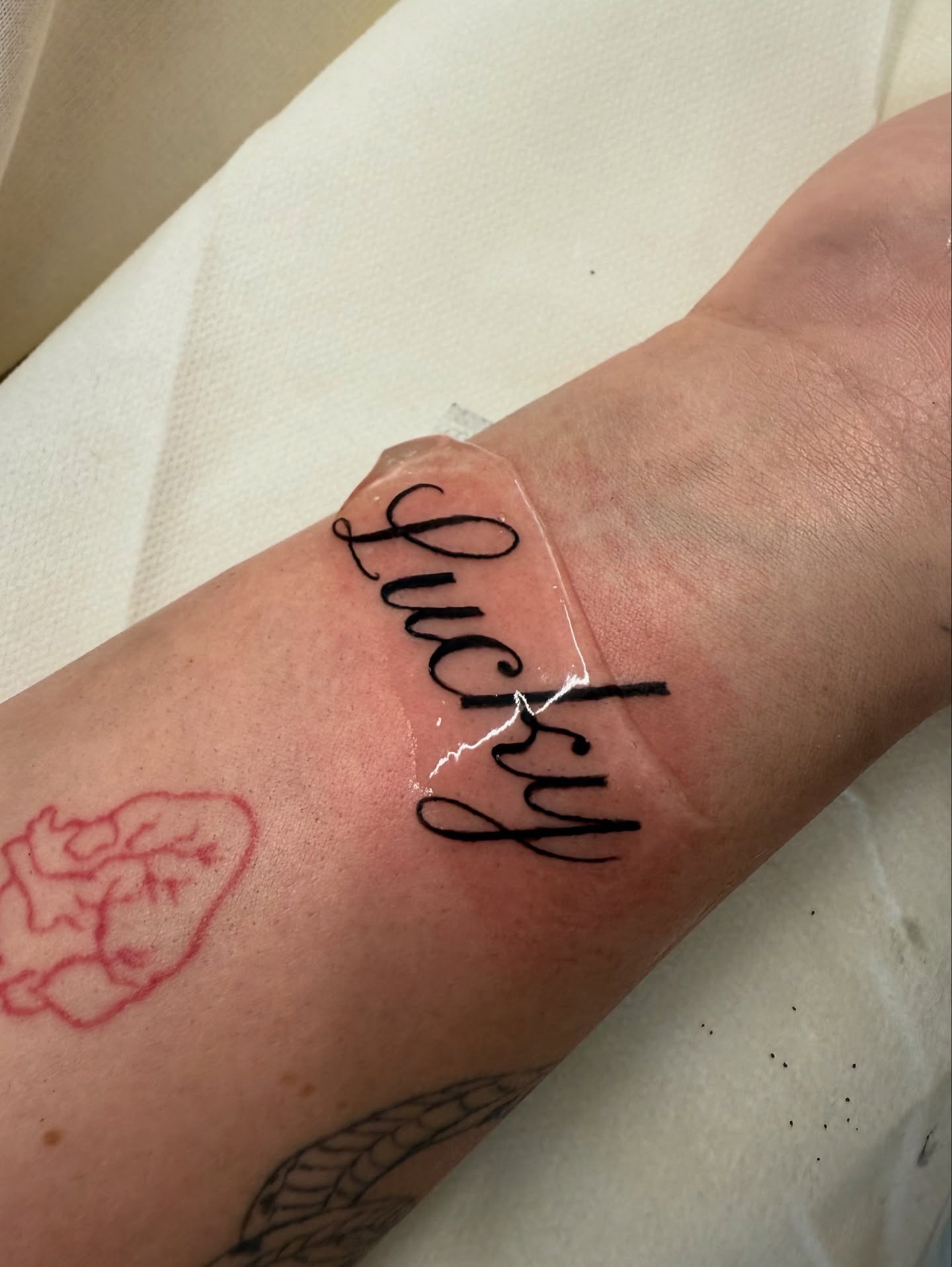 Fine-line script tattoo result