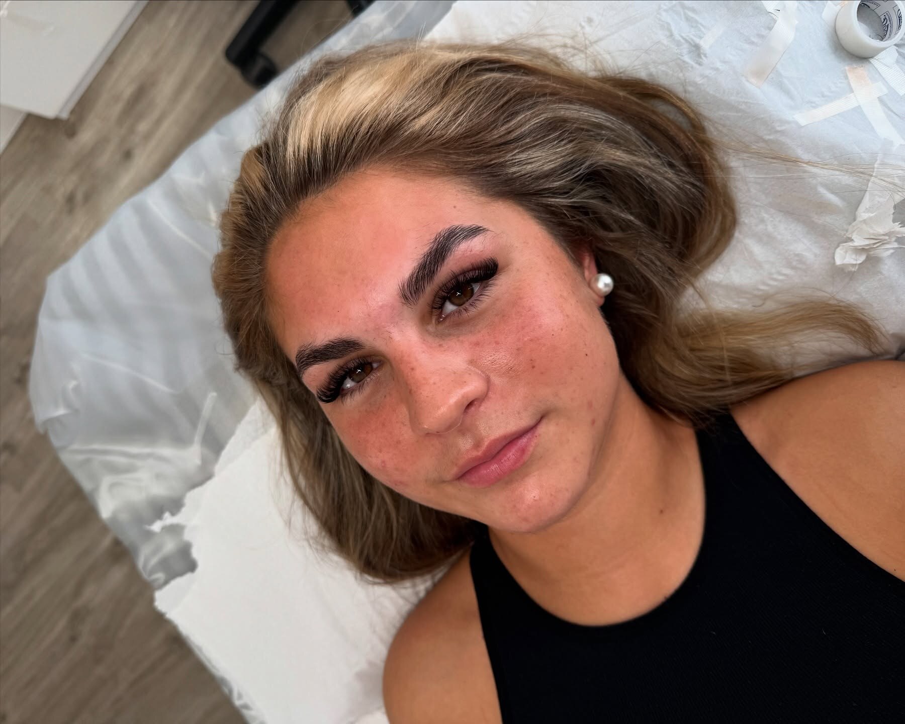 Dark-toned portrait showing finished brows and lashes
